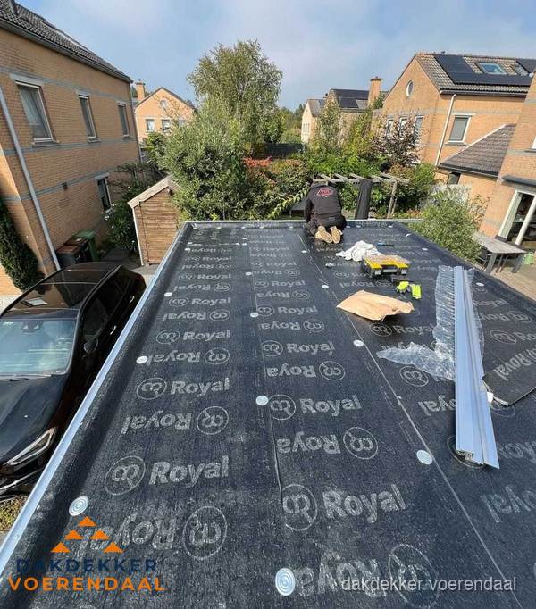 Dakdekker aan het werk op plat dak renovatie in Voerendaal