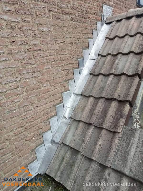 Loodslabben langs dakaansluiting bij bakstenen muur in Voerendaal