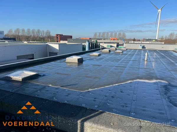 Plat dak bedrijfspand met bitumen dakbedekking en lichtkoepels in Voerendaal Plat dak bedrijfspand met bitumen dakbedekking en lichtkoepels in Voerendaal